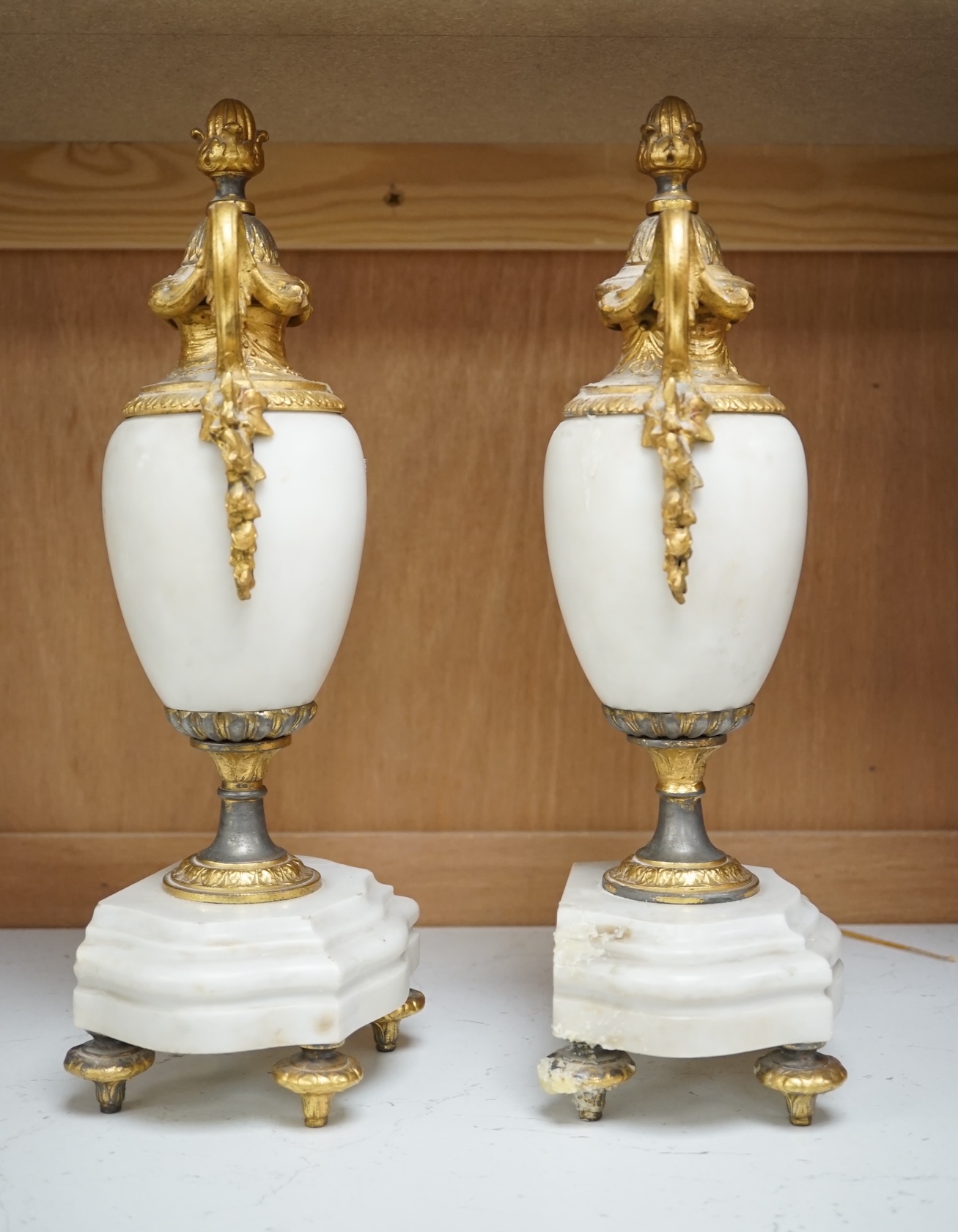 A pair of early 20th century white marble and gilt metal garnitures, 32cm. Condition - worn